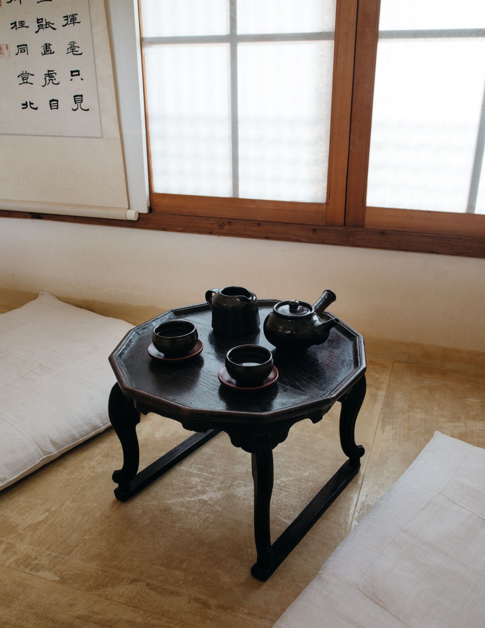 Image may contain Coffee Table Furniture Table Pottery Plate Cookware Pot Wood Home Decor Rug Desk and Cup