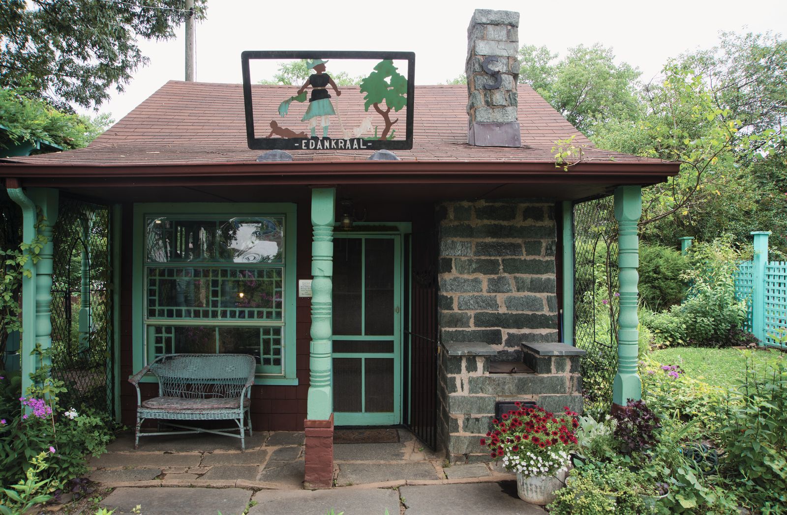 Image may contain Architecture Building House Housing Porch Cottage Bench Furniture Person Outdoors and Nature